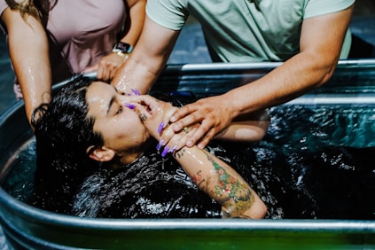 woman in grey t-shirt and black pants in water