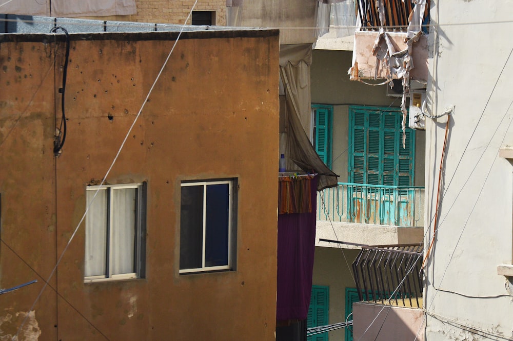 white window type ac unit on brown concrete building