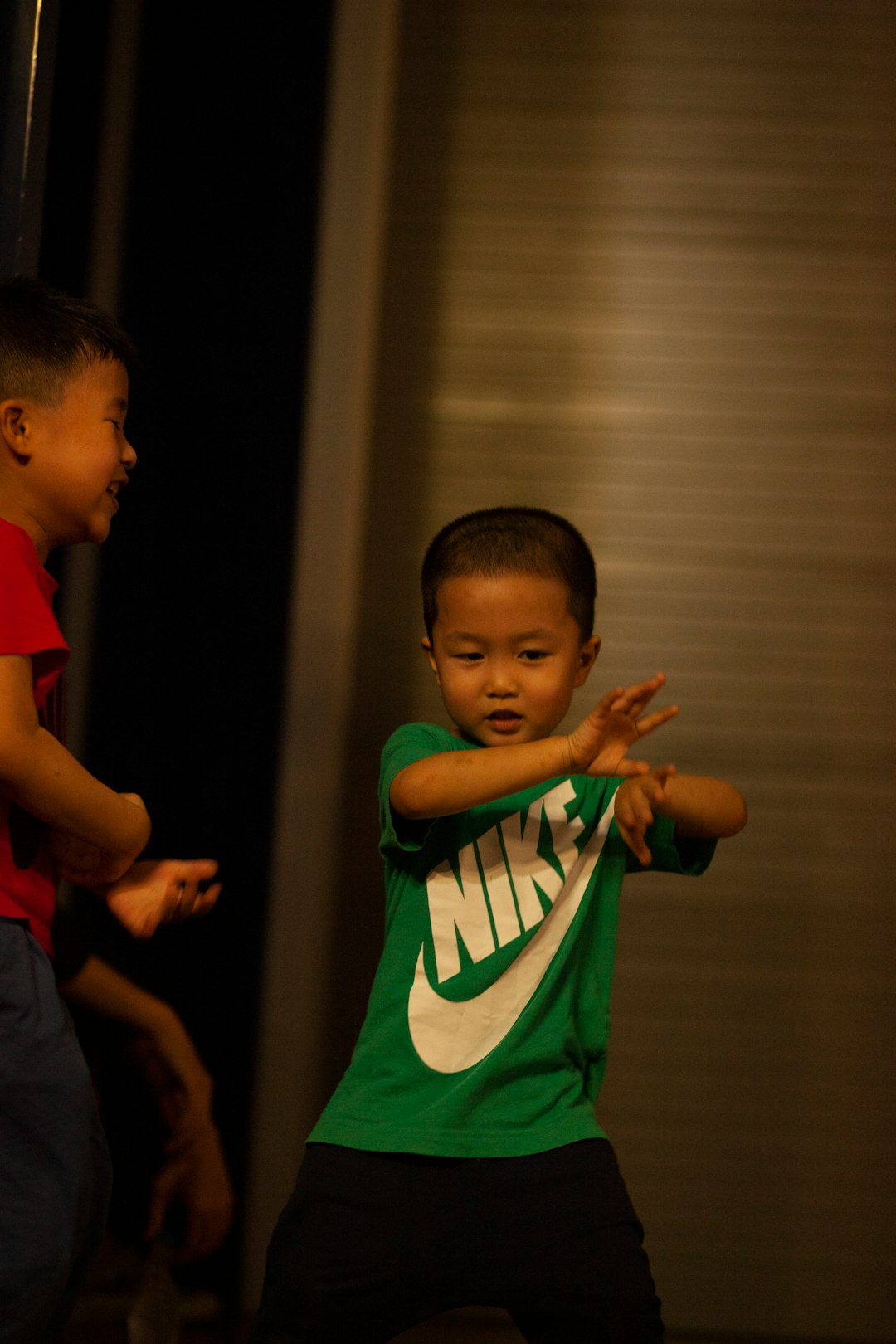 boy in green and white nike crew neck t-shirt standing