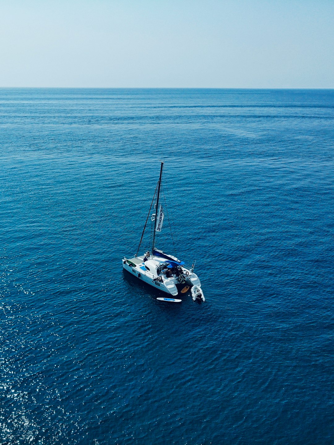 white and blue boat on sea during daytime