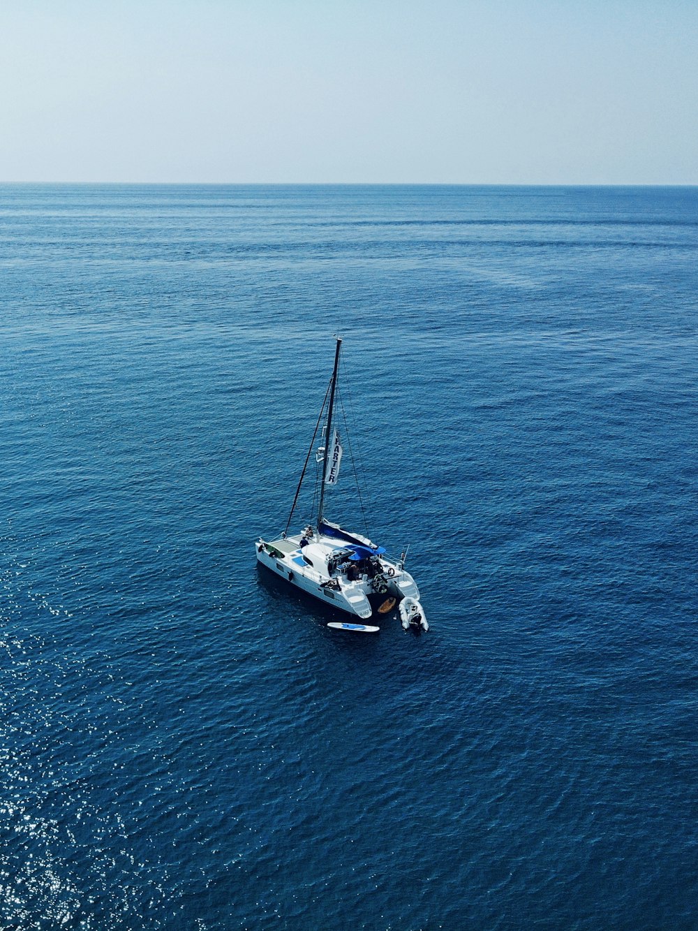 white and blue boat on sea during daytime