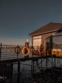 Couple sharing their first dance on a wooden deck overlooking the sea.