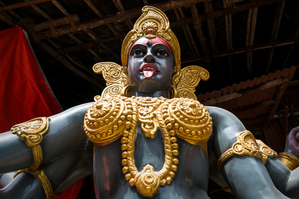 gold hindu deity statue in a room