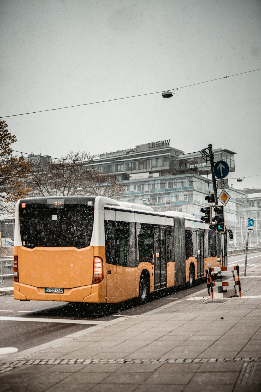 orange and white bus on road during daytime