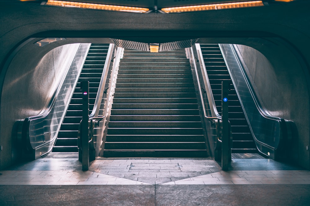 black and white staircase with stainless steel railings