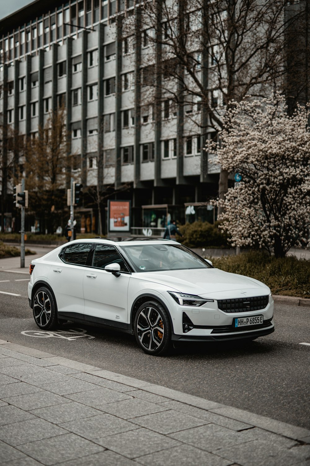 white mercedes benz coupe parked on roadside near building during daytime