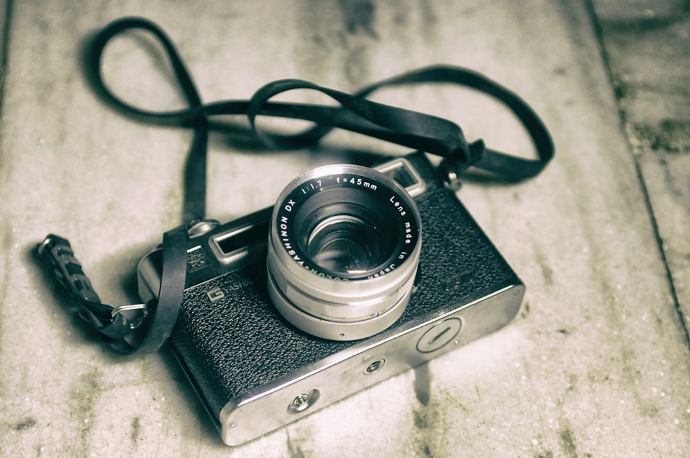 black and silver camera on white and black textile