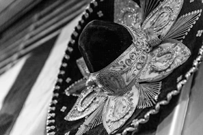Close-up of a handcrafted brown leather jaripeo hat with detailed stitching.