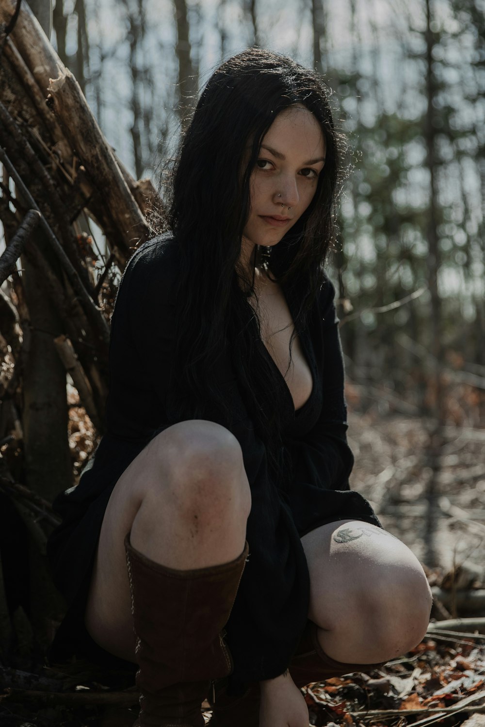 woman in black long sleeve shirt sitting on tree branch