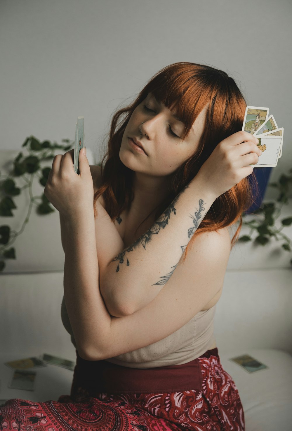 woman in white tank top holding white and black cigarette pack