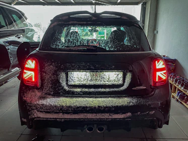 A family parking their car in a domestic garage, the boot lid shield clearly visible.