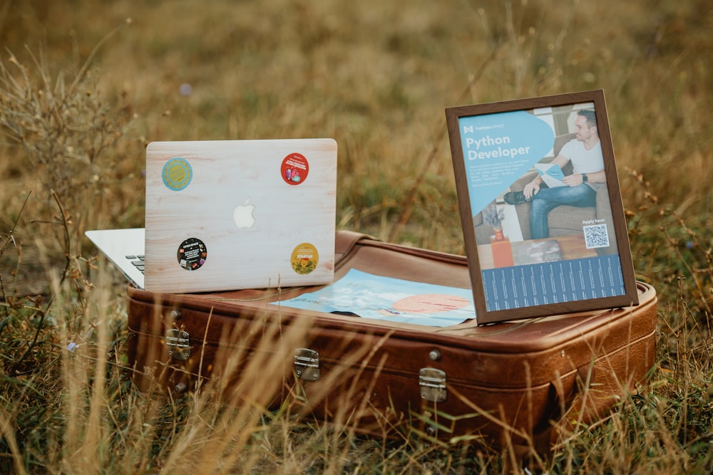 white laptop computer on brown wooden chest box