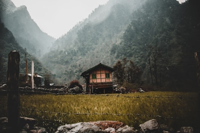 Cozy farmhouse patio overlooking a misty valley at dawn.