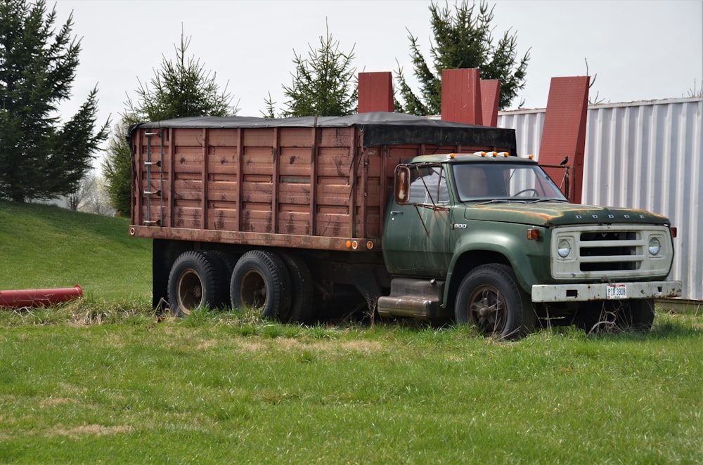 green and brown truck on green grass field during daytime