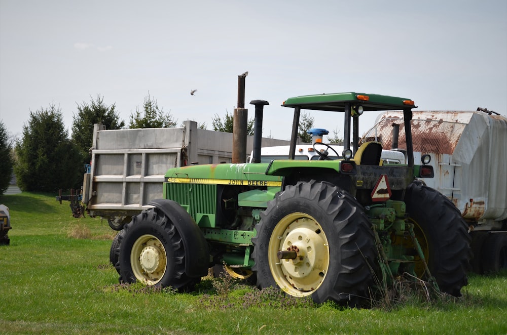 green tractor on green grass field during daytime