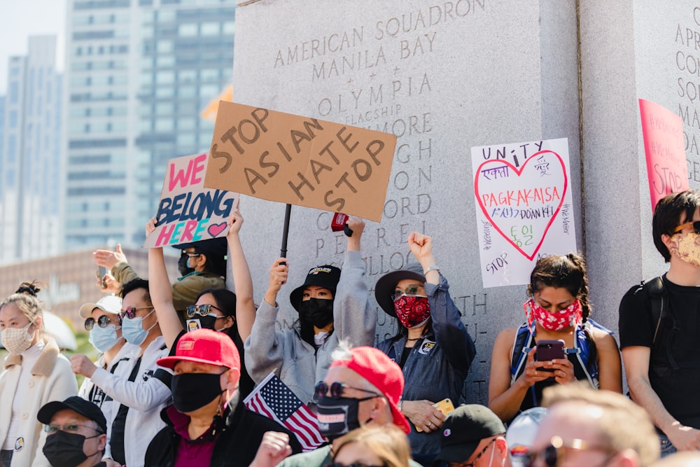 people holding white and red banner during daytime