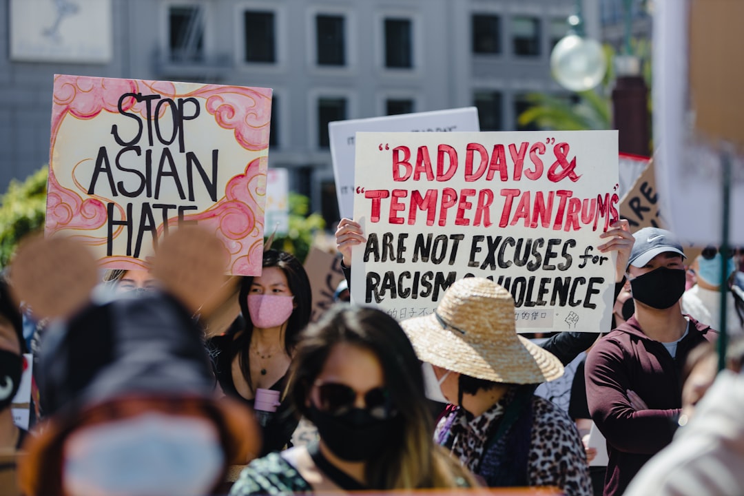 people holding white and red happy birthday signage during daytime