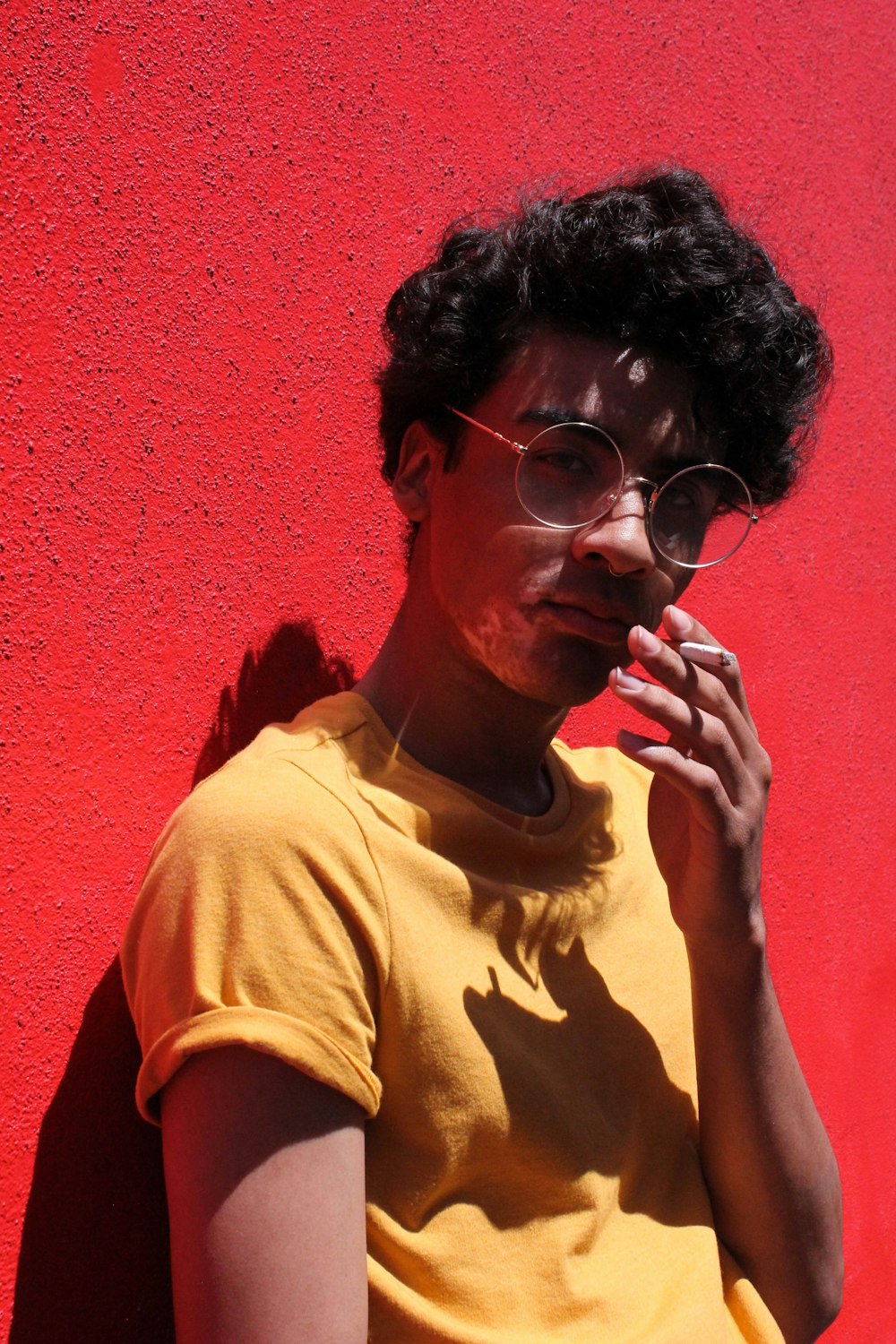 man in orange crew neck shirt wearing eyeglasses