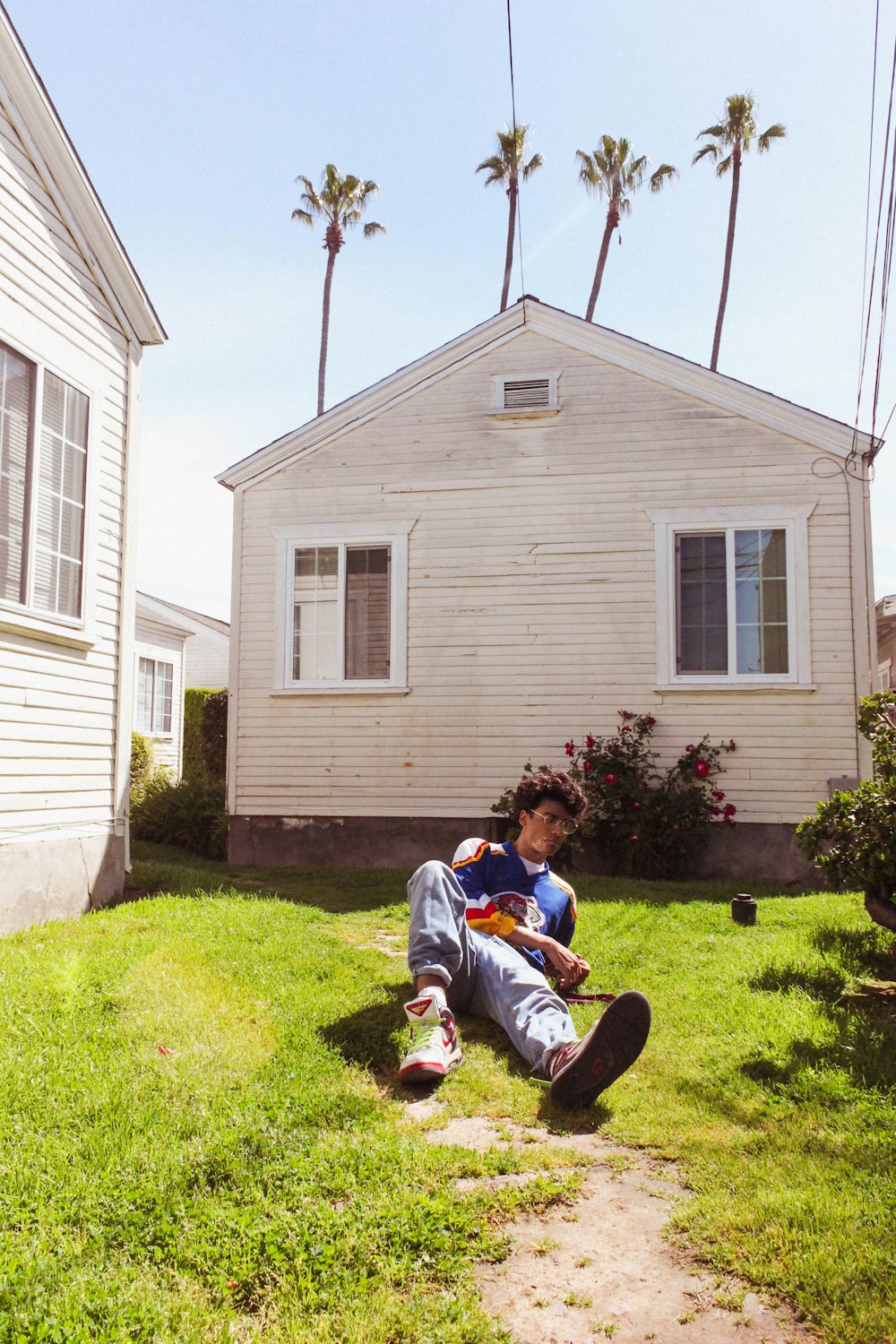 2 women sitting on green grass lawn during daytime