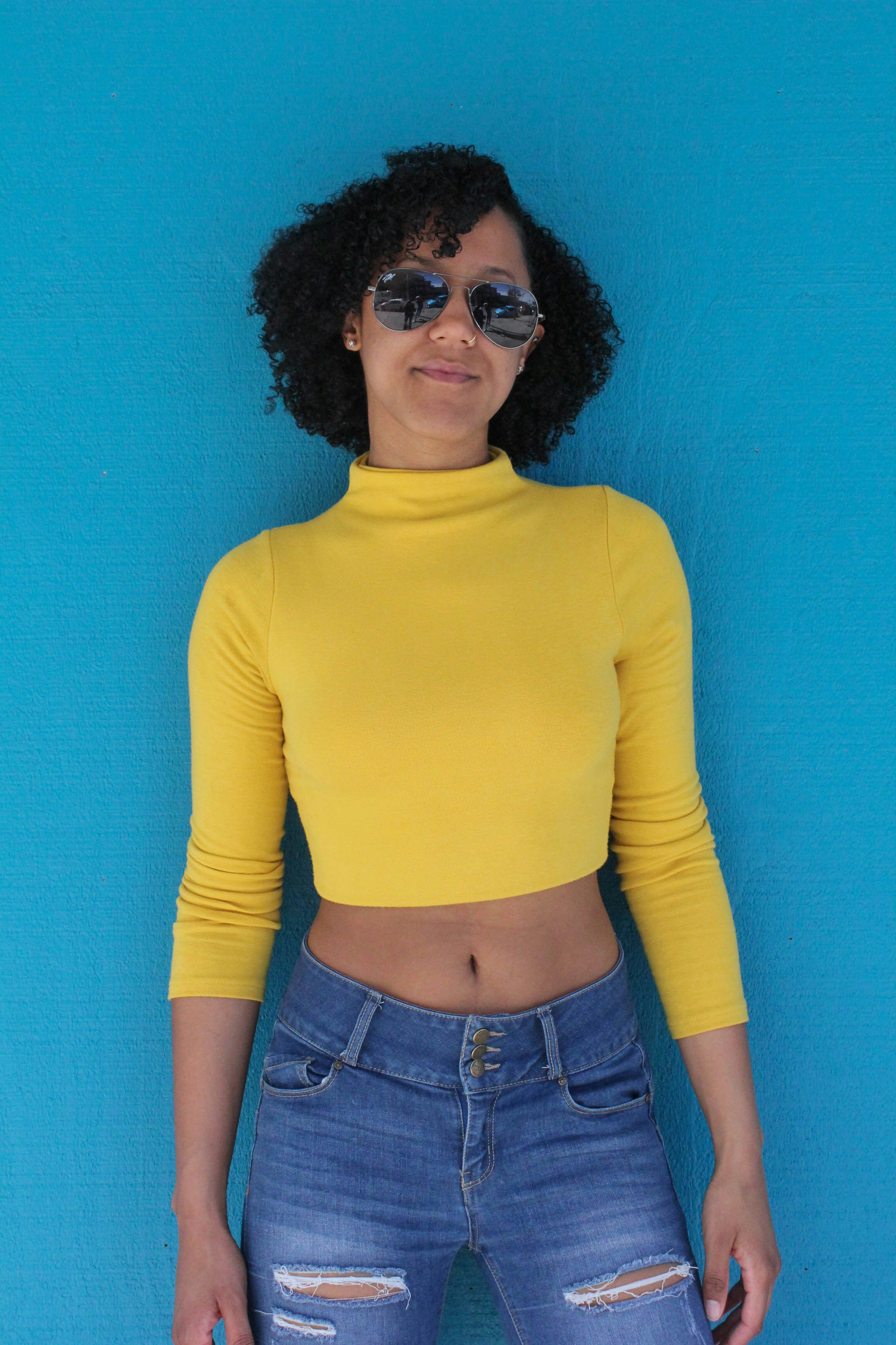 woman in yellow long sleeve shirt and blue denim bottoms