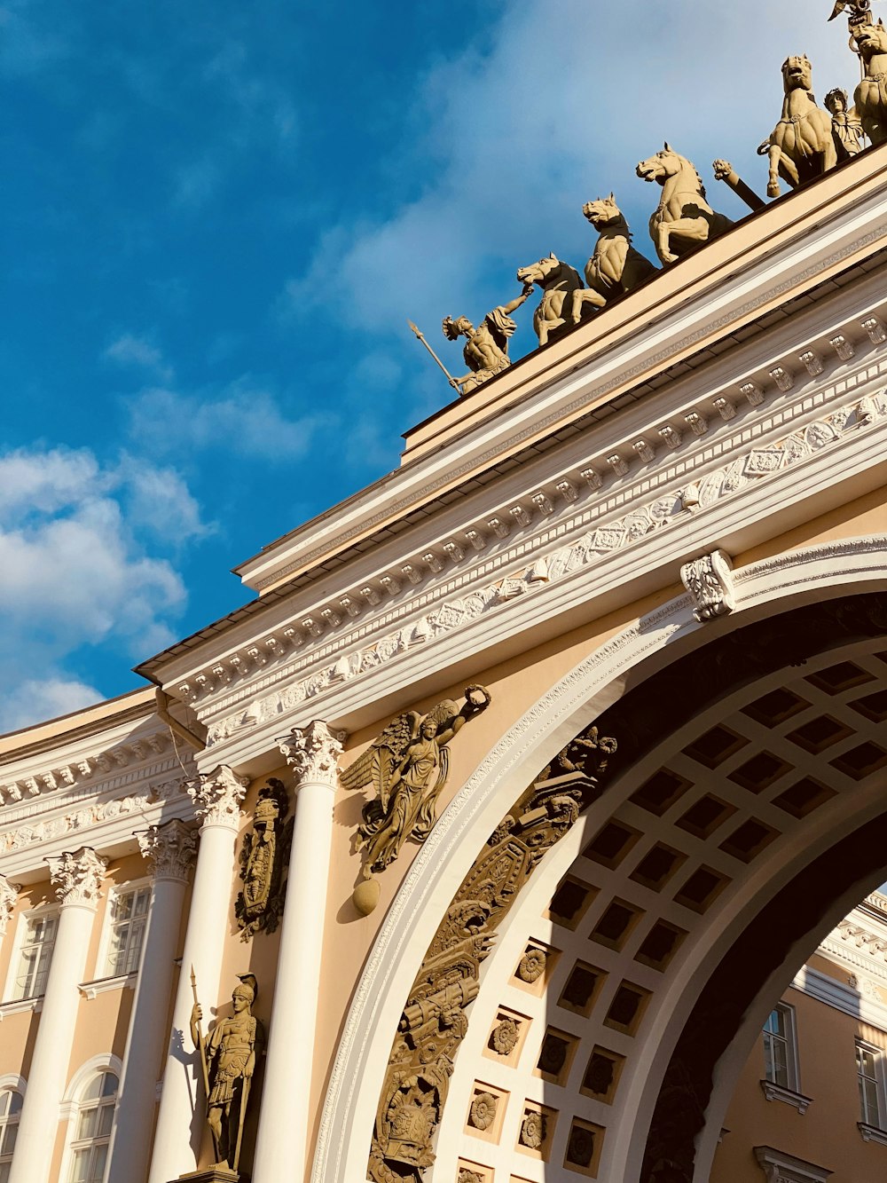 people walking on arch gate under blue sky during daytime