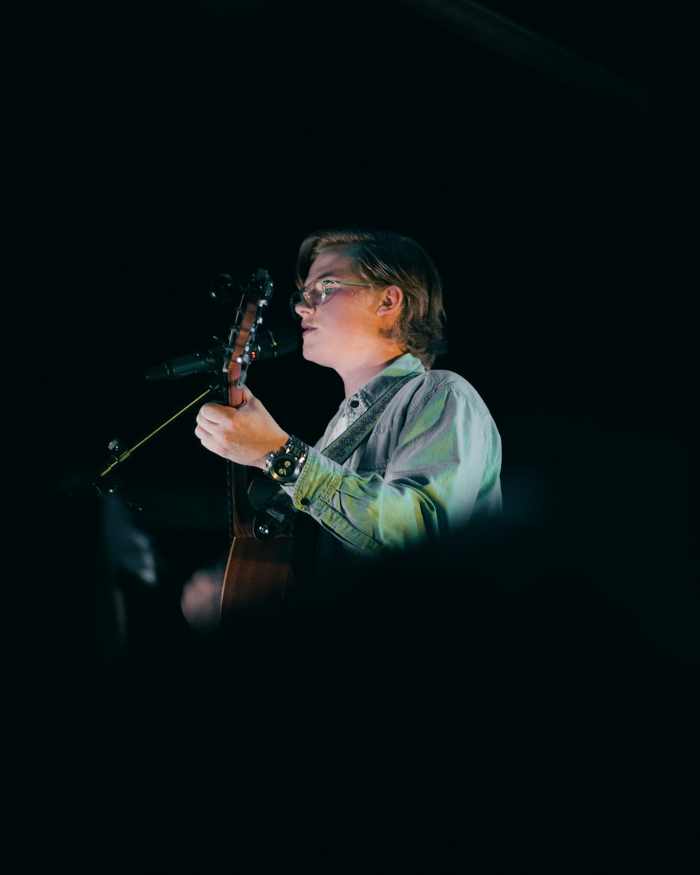 man in white dress shirt playing guitar