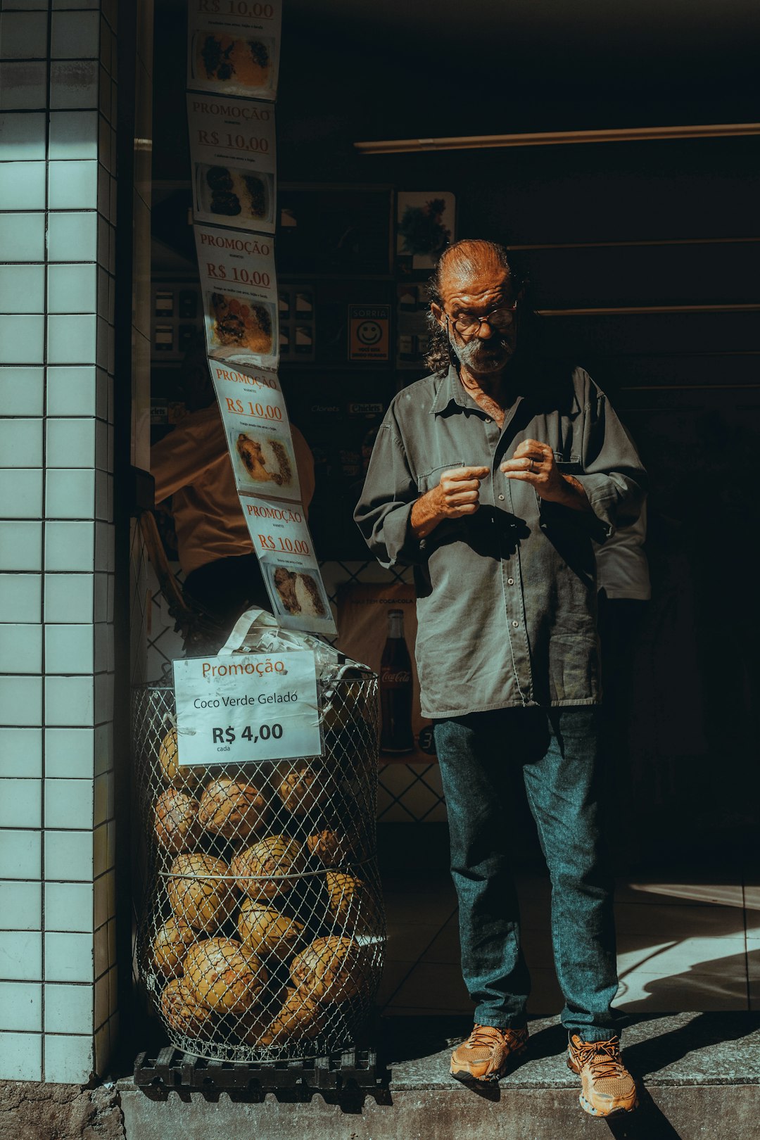 man in black jacket standing near glass window