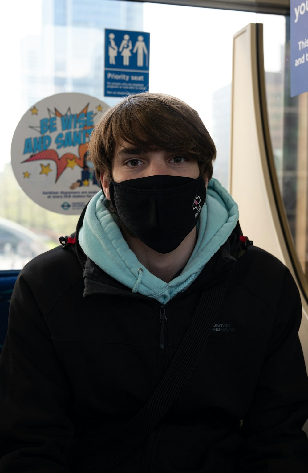 man in black zip up hoodie wearing black mask