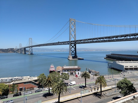 white and black bridge under blue sky during daytime