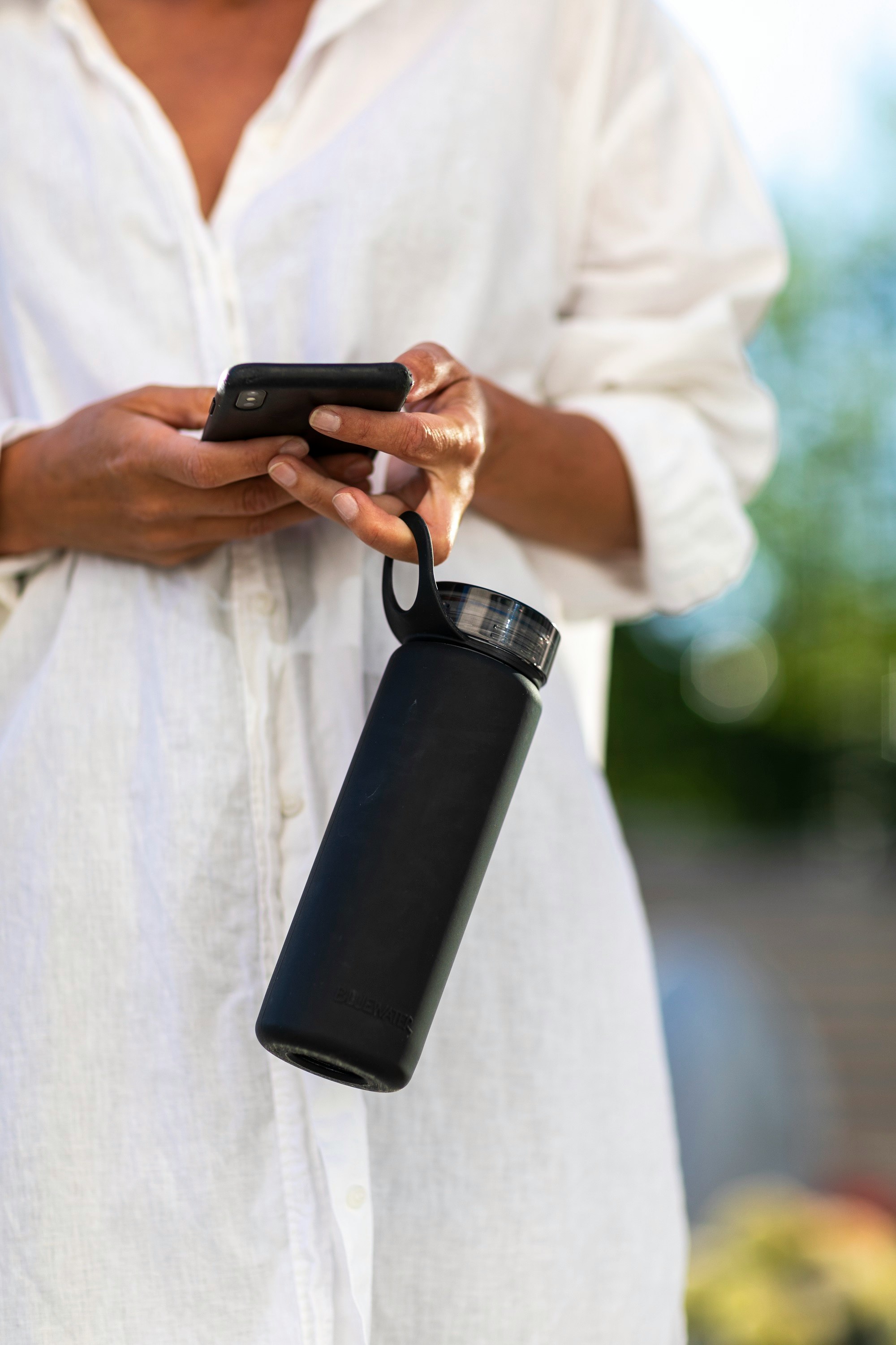 person holding black and silver tumbler