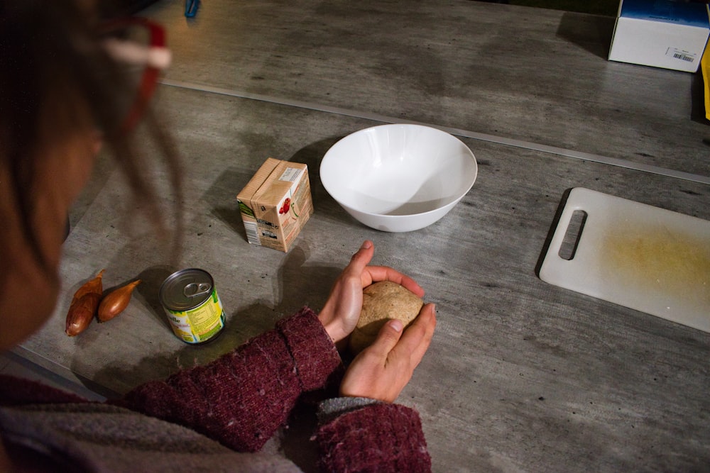 person holding white ceramic bowl