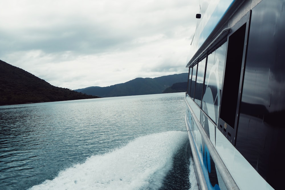 white and blue boat on sea during daytime