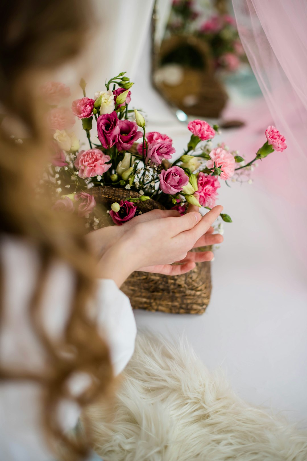 pink roses in brown woven basket