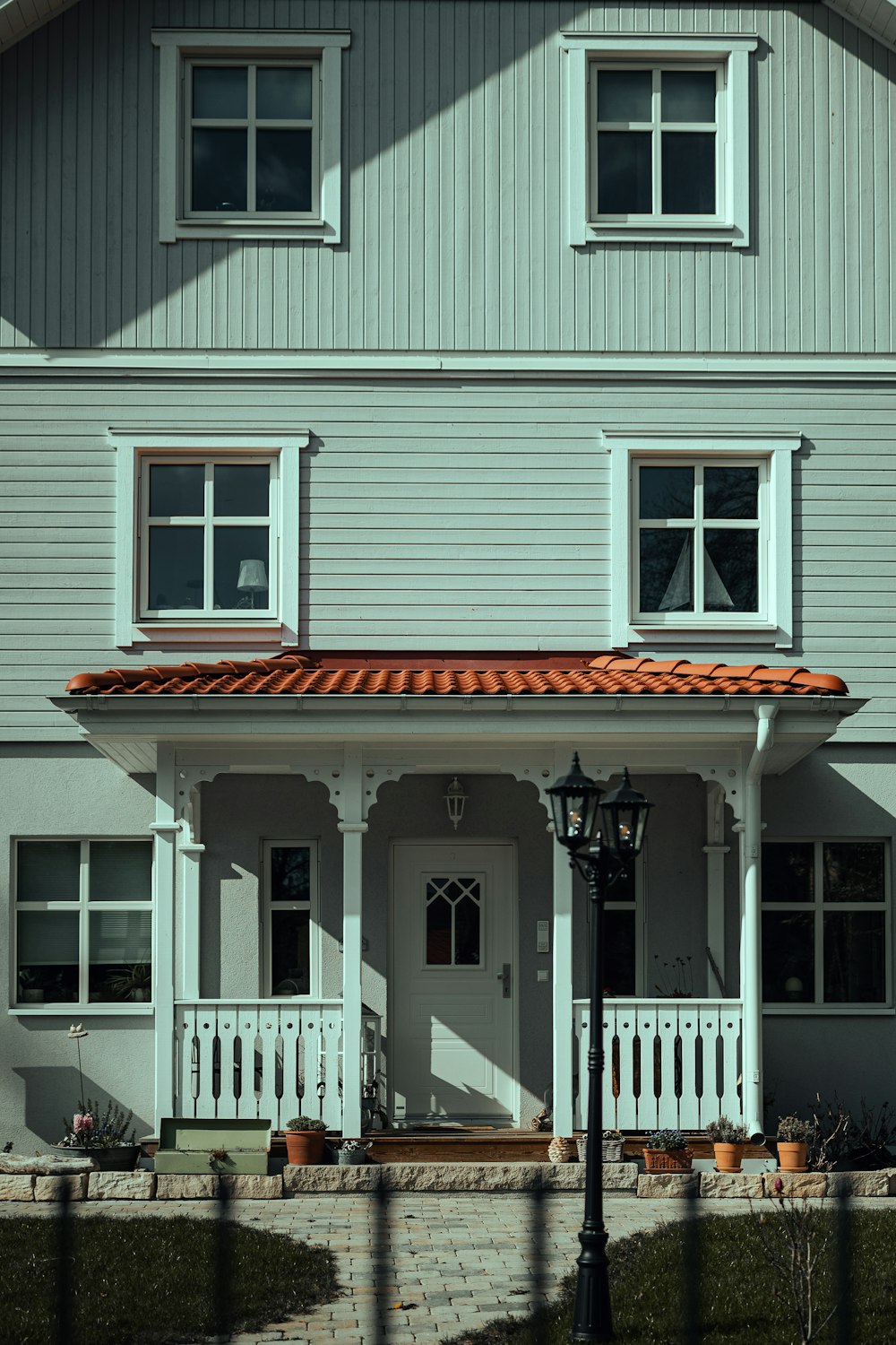 white wooden house with white wooden fence