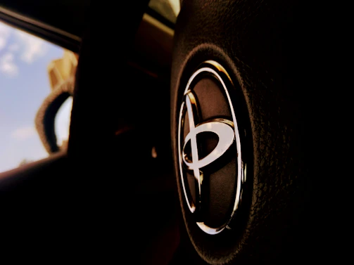 Close-up of the dashboard and hands on the wheel inside the Toyota Matrix during a lesson.