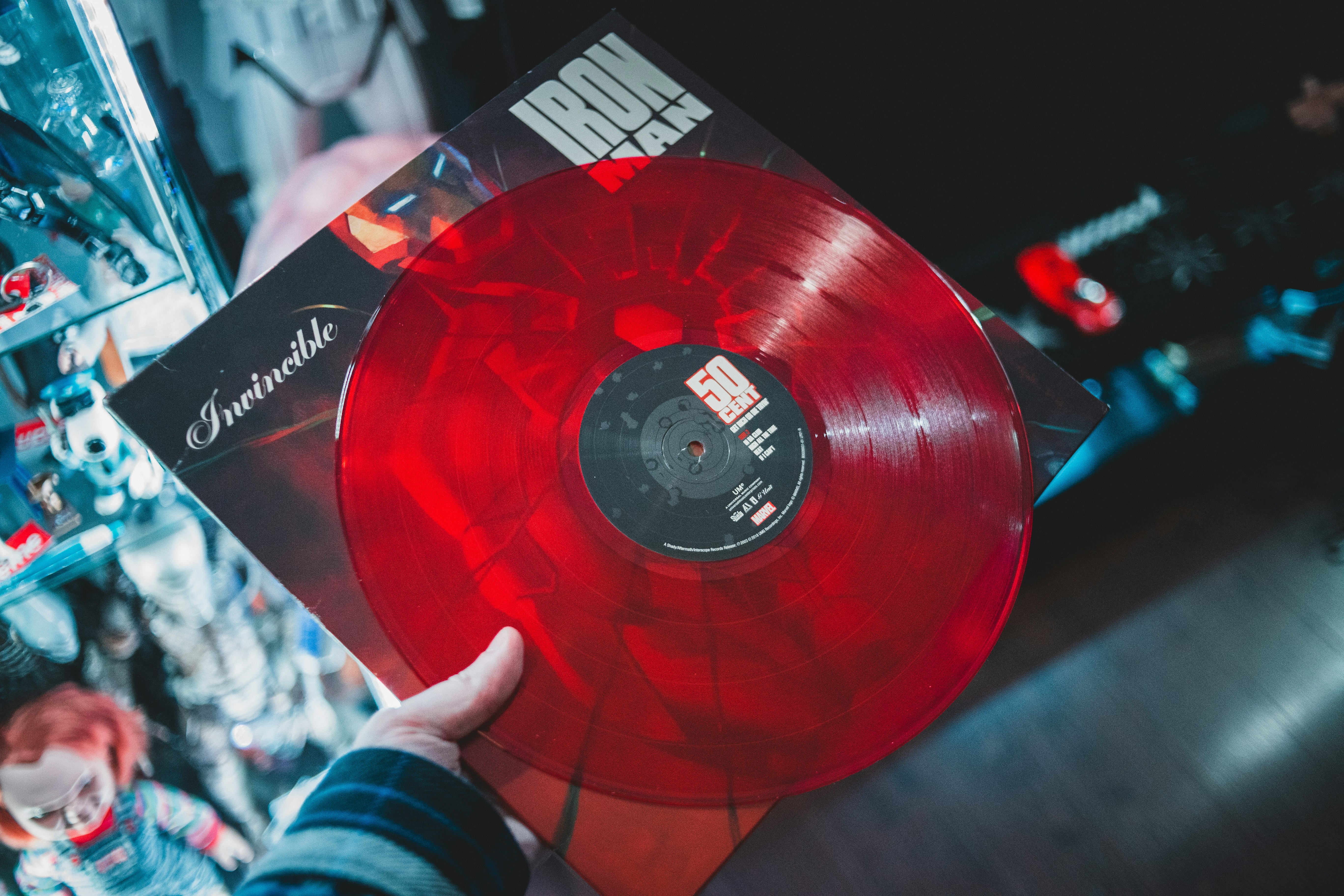 person holding red vinyl record