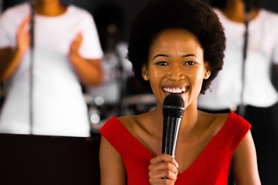 man in red sleeveless shirt holding microphone