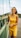 woman in yellow tank dress smiling