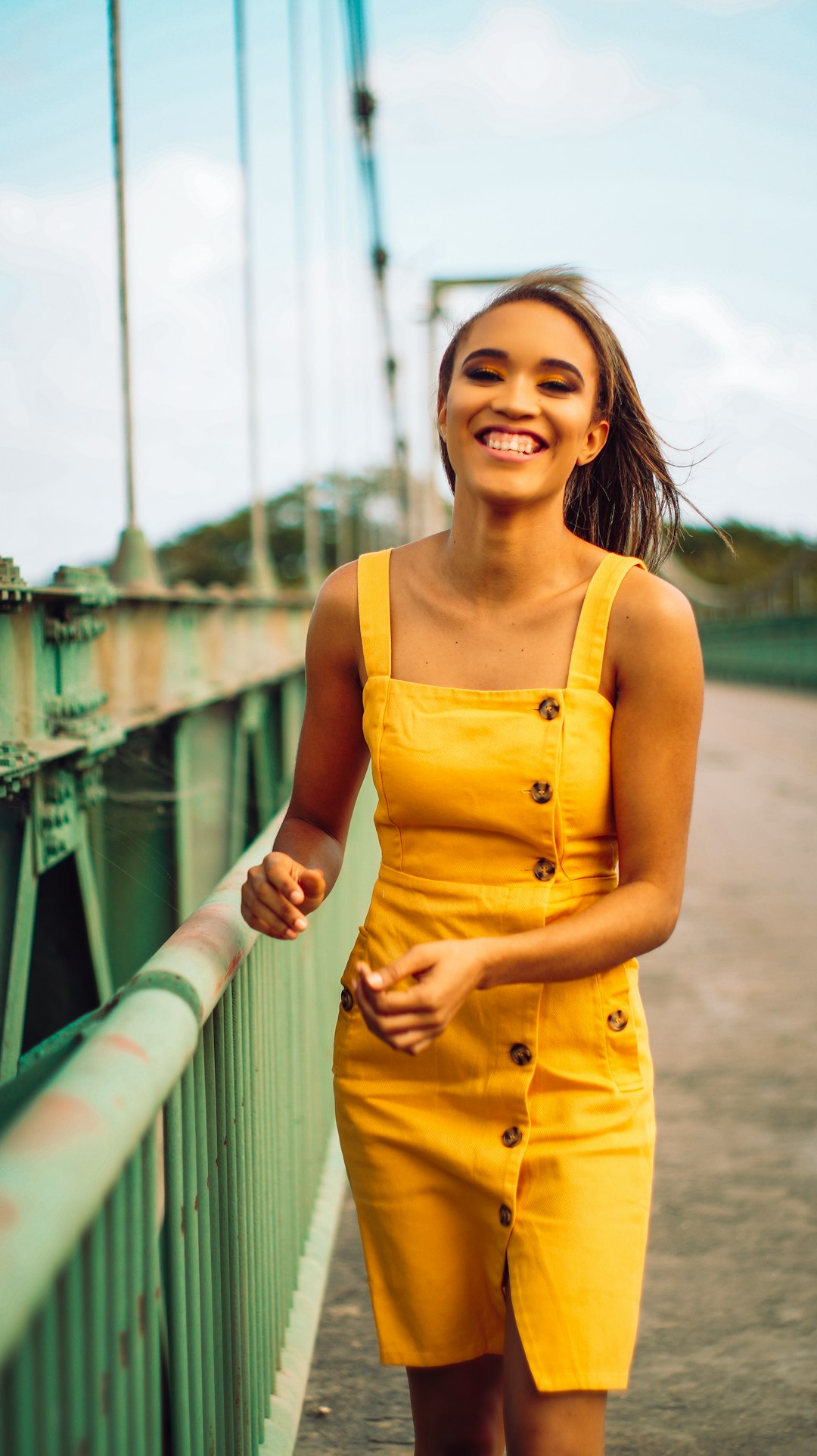woman in yellow tank dress smiling