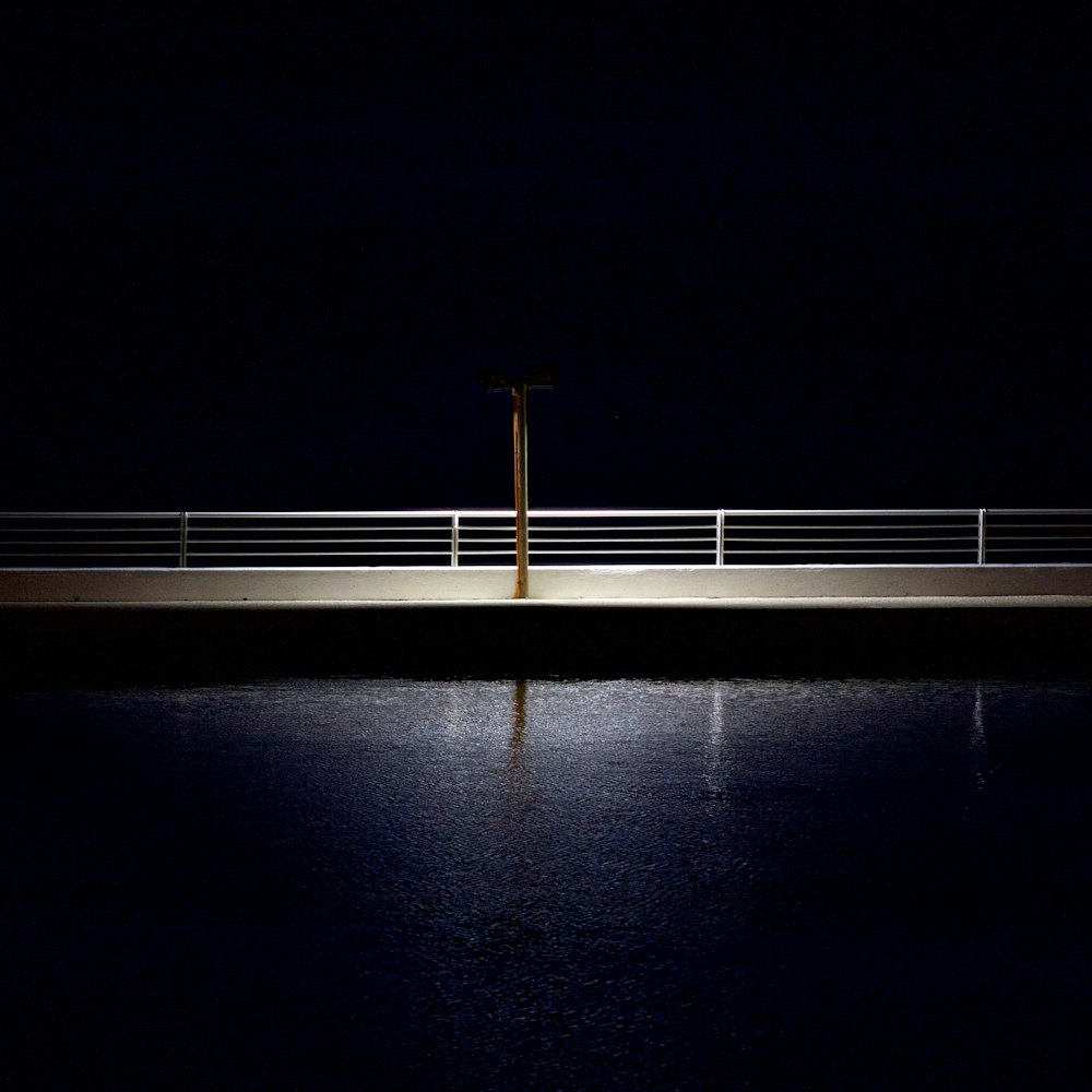 white metal railings on black surface