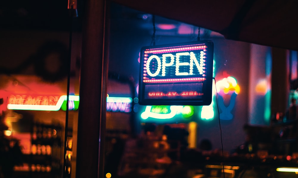 red and white open neon sign