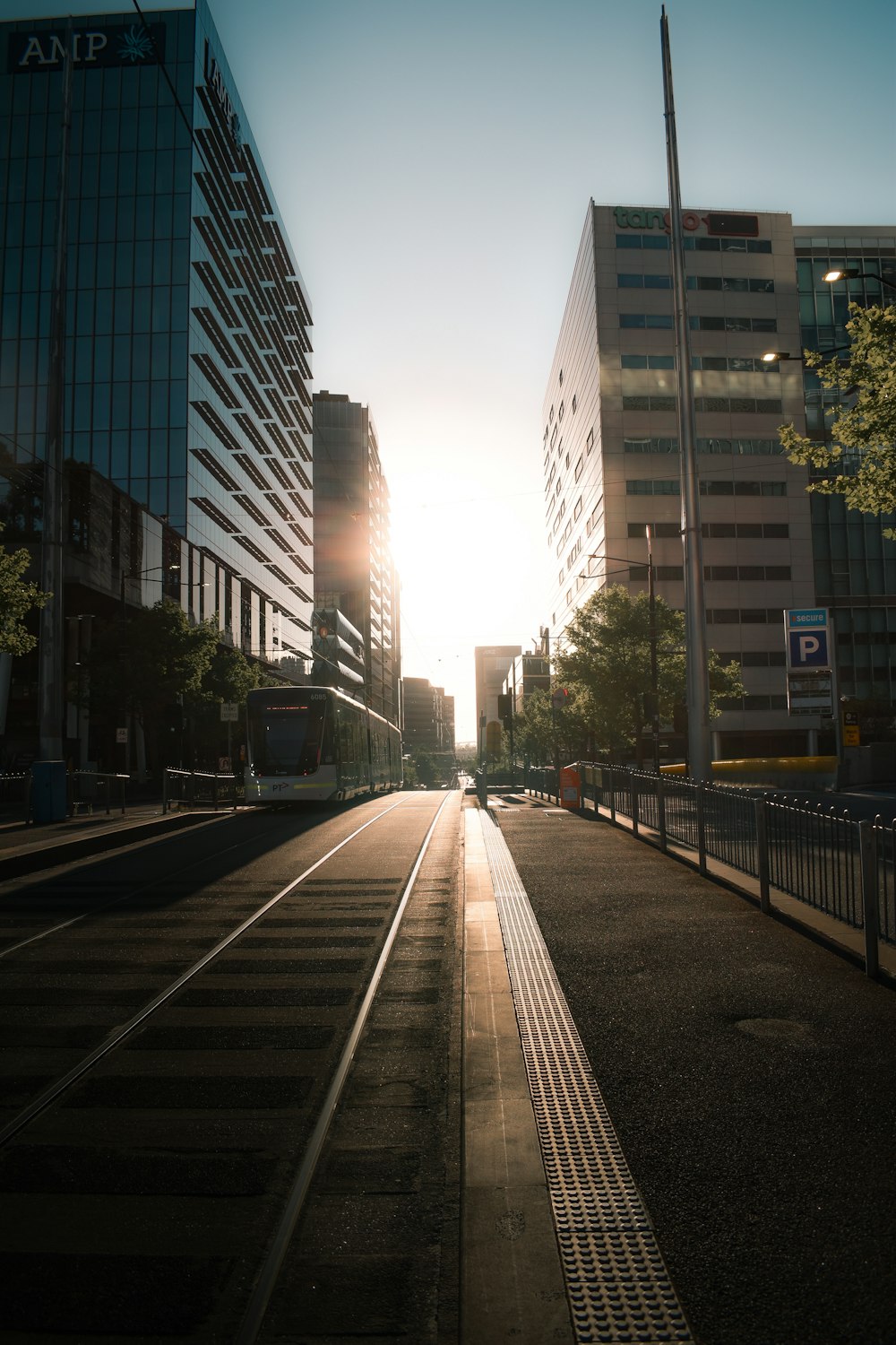 gray concrete road between high rise buildings during daytime