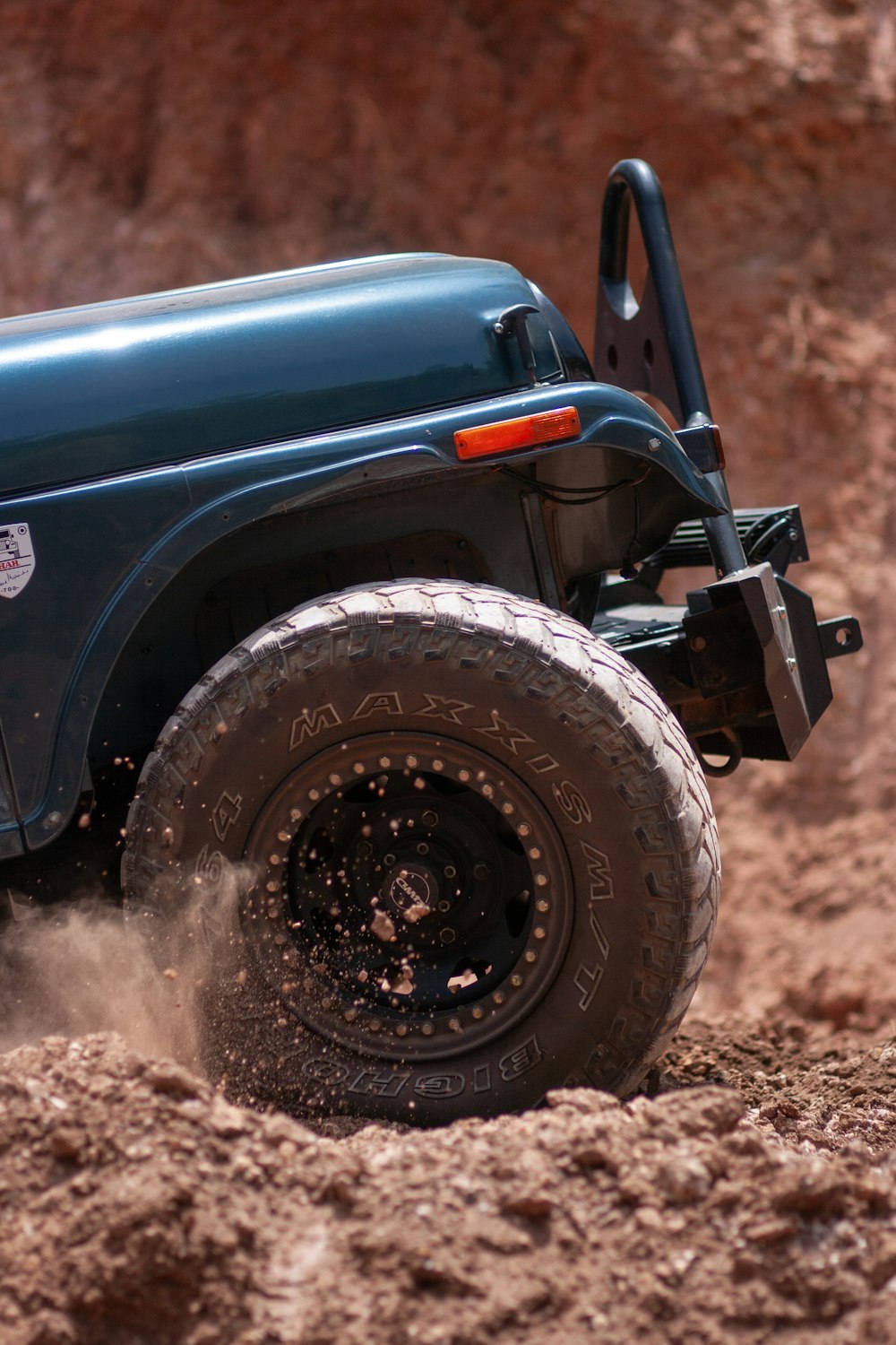 blue car on brown soil