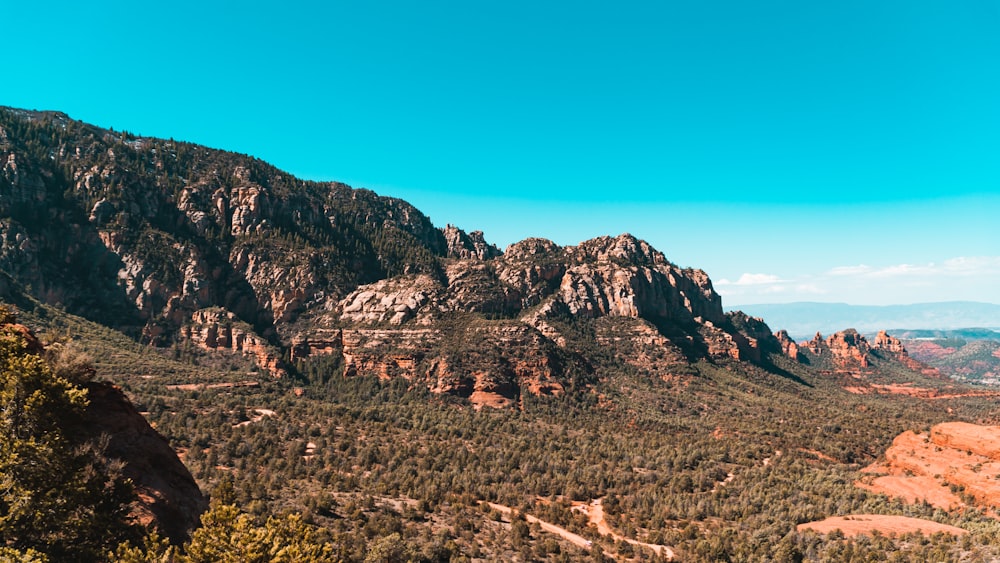 brown rocky mountain under blue sky during daytime