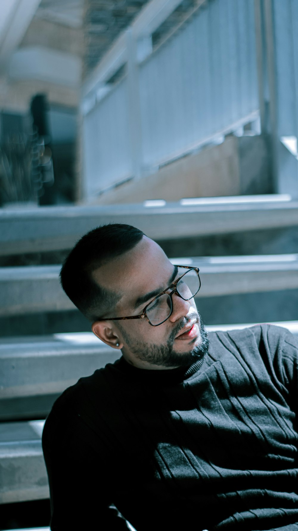 man in black crew neck shirt wearing black framed eyeglasses