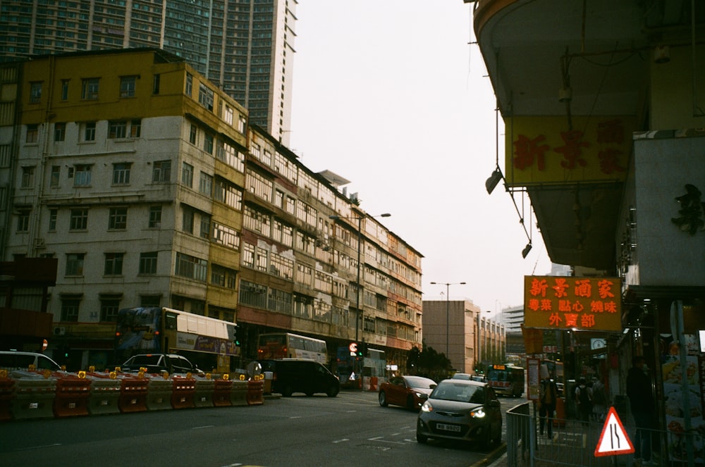 cars parked on side of the road near buildings during daytime