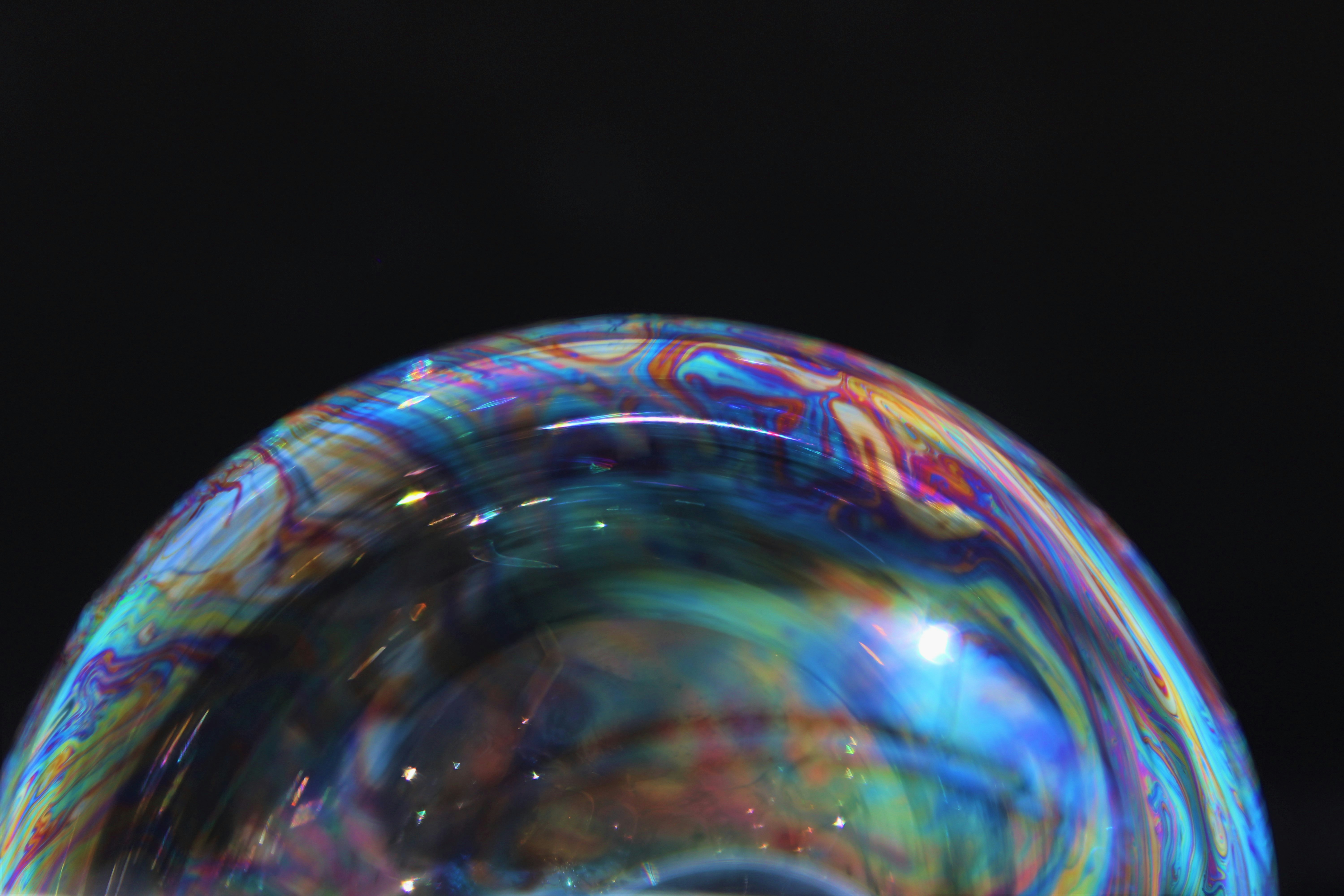 Close-up photograph of an iridescent soap bubble reflecting light
