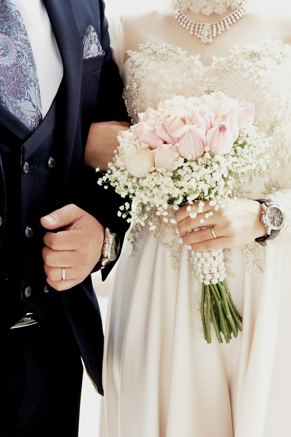 woman in white wedding dress holding bouquet of flowers