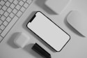 white apple keyboard on white table, who do I call for help
