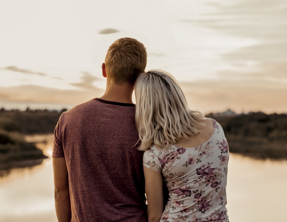 man and woman standing on brown field during daytime